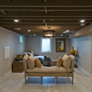 This is an example of a large country fully buried basement in Kansas City with grey walls, light hardwood flooring and grey floors.