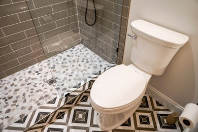 Small transitional gray tile and ceramic tile marble floor and multicolored floor bathroom photo in Atlanta with white cabinets, white walls, an undermount sink, marble countertops and white countertops