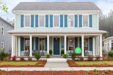Inspiration for a large timeless blue two-story exterior home remodel in Charleston