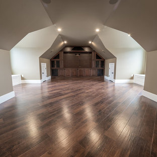 This is an example of a large rural enclosed home cinema in Edmonton with beige walls, vinyl flooring, a built-in media unit and multi-coloured floors.