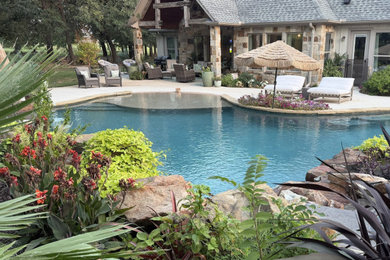 Large mountain style natural pool photo in Dallas