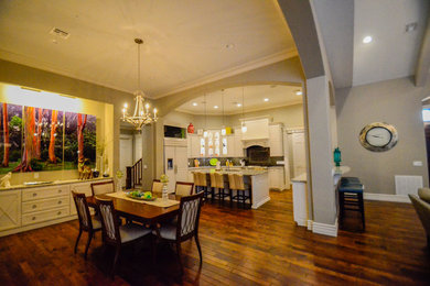 Large transitional open plan dining in Other with dark hardwood floors.
