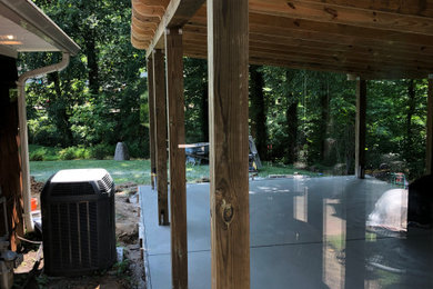 Example of a mid-sized backyard concrete patio design in Baltimore with a pergola