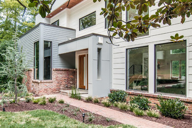 Mid-sized trendy white two-story concrete fiberboard flat roof photo in Nashville