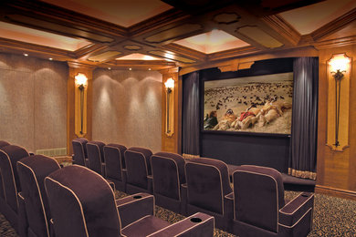 This is an example of a large retro enclosed home cinema in Cincinnati with beige walls, carpet and a projector screen.
