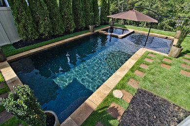 Photo of a mid-sized contemporary backyard rectangular pool in Other with a hot tub.