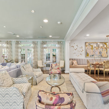 Spacious and Elegant Living Room with Floor-to-Ceiling Windows and Vibrant Patte