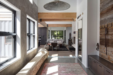 Trendy concrete floor hallway photo in Chicago with white walls