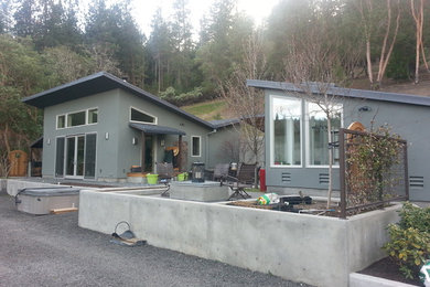 Example of a small minimalist gray one-story stucco exterior home design in Denver with a shed roof