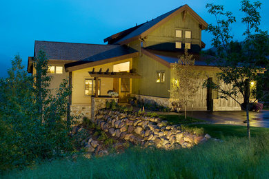 Inspiration for a mid-sized country three-storey green exterior in Denver with stone veneer and a gable roof.