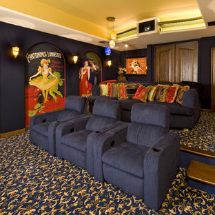 Photo of an eclectic enclosed home cinema in Los Angeles with carpet, a projector screen and multi-coloured floors.