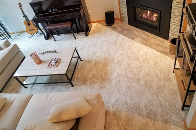 Inspiration for a mid-sized contemporary open concept carpeted living room remodel in Minneapolis with beige walls and a wall-mounted tv