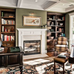 Design ideas for a mid-sized traditional study room in San Francisco with green walls, dark hardwood floors, a standard fireplace, a plaster fireplace surround and a freestanding desk.