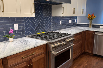 Example of a mid-sized transitional medium tone wood floor and brown floor eat-in kitchen design in Wilmington with an undermount sink, shaker cabinets, medium tone wood cabinets, quartzite countertops, blue backsplash, subway tile backsplash, stainless steel appliances, an island and gray countertops