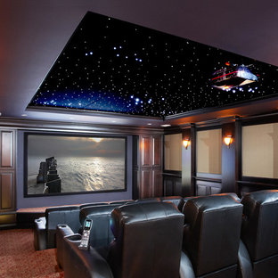 Inspiration for an expansive modern enclosed home cinema in Atlanta with beige walls, carpet, red floors and a projector screen.