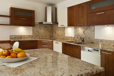 Inspiration for a large transitional u-shaped eat-in kitchen remodel in Salt Lake City with a double-bowl sink, shaker cabinets, medium tone wood cabinets, granite countertops, beige backsplash, stone slab backsplash, white appliances and an island