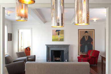 Example of a trendy open concept medium tone wood floor living room design in New York with white walls, no tv, a standard fireplace and a stone fireplace