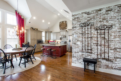 This is an example of a mid-sized transitional eat-in kitchen in Atlanta with medium hardwood floors and brown floor.
