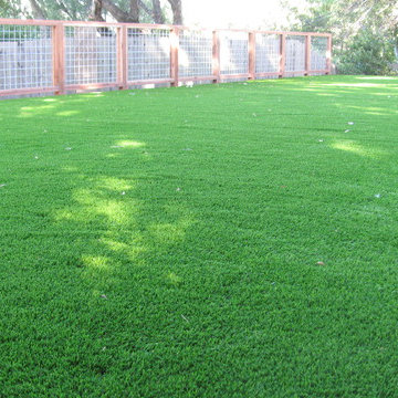 Low angle shot of turf sports field and galvanized steel fence