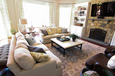 Large transitional enclosed dark wood floor living room photo in DC Metro with beige walls, a standard fireplace, a stone fireplace and a wall-mounted tv