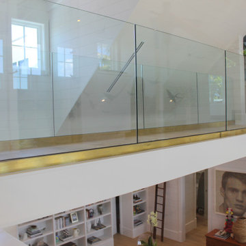 Glass Balustrade with Aluminum Base Rail Finished with Satin Brass Cladding