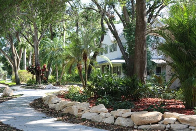 Inspiration for a large tropical shade front yard landscaping in Orlando.