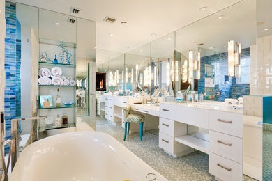 Bathroom - large tropical master blue tile and mosaic tile mosaic tile floor and multicolored floor bathroom idea in Miami with flat-panel cabinets, white cabinets, a one-piece toilet, beige walls, an undermount sink, quartz countertops and a hinged shower door