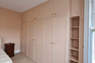 Large elegant master carpeted, beige floor and tray ceiling bedroom photo in London with pink walls