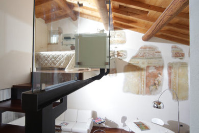 Esempio di un piccolo soggiorno minimalista stile loft con pareti bianche, parquet scuro e travi a vista