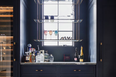 Example of a transitional home bar design in New York