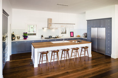 Photo of a transitional kitchen in Melbourne with recessed-panel cabinets, grey cabinets and with island.