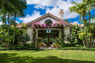 Inspiration for a large tropical partial sun backyard formal garden in New York.