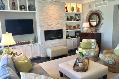 Mid-sized beach style formal and enclosed dark wood floor and brown floor living room photo with gray walls, a standard fireplace, a stone fireplace and no tv