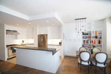Open concept kitchen - mid-sized contemporary l-shaped ceramic tile open concept kitchen idea in New York with an undermount sink, flat-panel cabinets, white cabinets, quartz countertops, white backsplash, ceramic backsplash, stainless steel appliances and an island