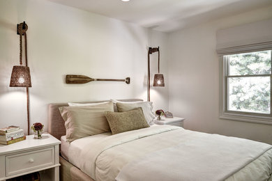 Example of a beach style bedroom design in New York with white walls