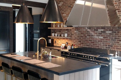 Eat-in kitchen - large transitional galley limestone floor and gray floor eat-in kitchen idea in New York with an integrated sink, recessed-panel cabinets, gray cabinets, quartz countertops, multicolored backsplash, brick backsplash, paneled appliances and an island