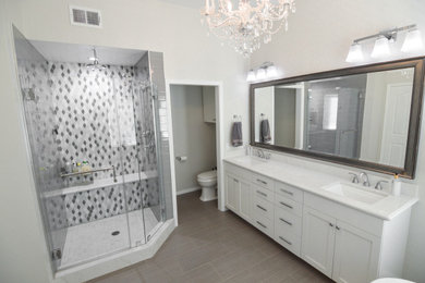 Example of a huge minimalist master porcelain tile, beige floor and double-sink bathroom design in Los Angeles with shaker cabinets, white cabinets, a two-piece toilet, an undermount sink, quartz countertops, a hinged shower door, white countertops and a built-in vanity