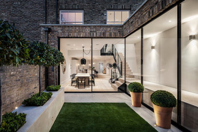 Mid-sized contemporary patio in London.