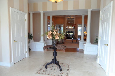 Example of a huge transitional foyer design in Other