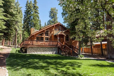 Large traditional two-story wood gable roof idea in Sacramento