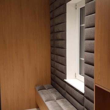Entryway upholstered wall with sitting bench.