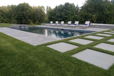 Design ideas for a large contemporary full sun backyard stone landscaping.