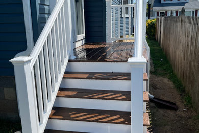 Example of a mid-sized classic backyard deck design in Other