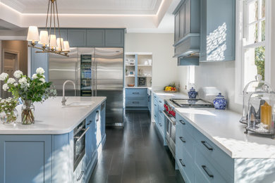 Photo of an expansive classic open plan kitchen in Sydney with a double-bowl sink, shaker cabinets, blue cabinets, engineered stone countertops, white splashback, dark hardwood flooring, an island, white worktops and a vaulted ceiling.