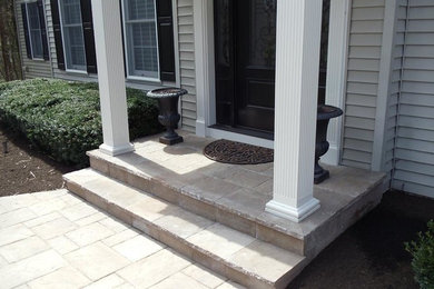 Photo of a mid-sized craftsman partial sun front yard concrete paver landscaping in Philadelphia.