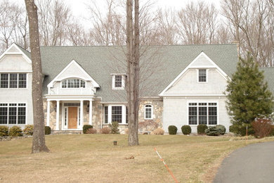 Large elegant gray two-story wood house exterior photo in Bridgeport