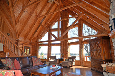 Example of a huge mountain style formal and open concept medium tone wood floor living room design in Orange County with a standard fireplace, a stone fireplace and no tv