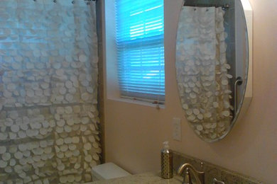 Example of a mid-sized classic 3/4 bathroom design in DC Metro with a two-piece toilet, dark wood cabinets, beige walls, an undermount sink and granite countertops