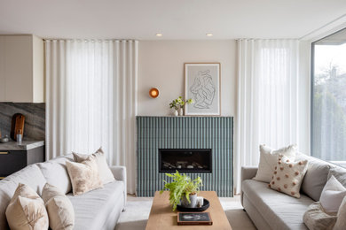 Living room - mid-sized contemporary formal and open concept light wood floor and beige floor living room idea in Vancouver with white walls, a standard fireplace, a tile fireplace and no tv