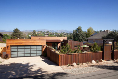 Photo of a mid-sized contemporary one-storey brown house exterior in Santa Barbara with wood siding and a flat roof.